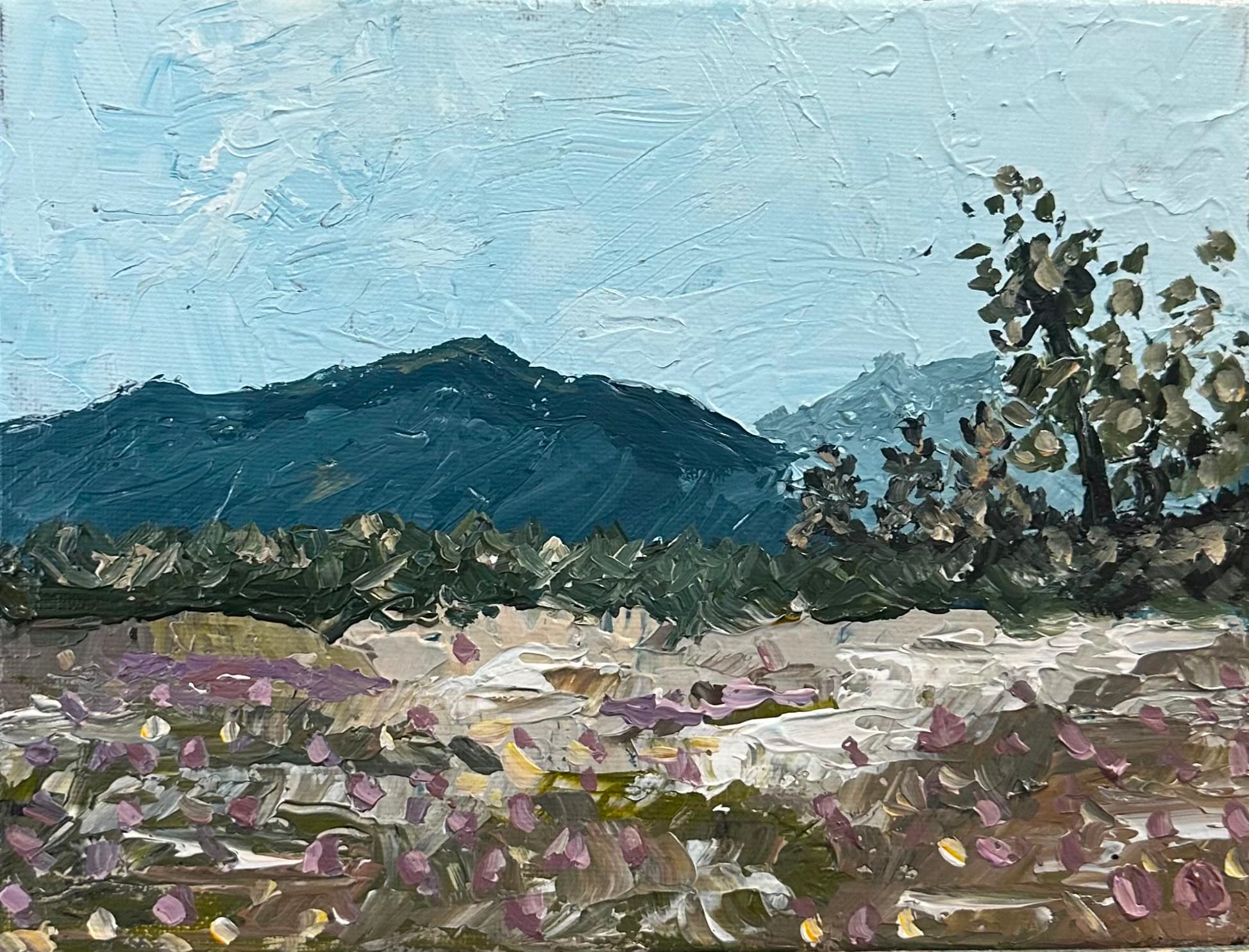 Palette-knife painting of a dark blue-grey mountain ridge under a pale sky, framed by wind-bent pine trees on the right and a foreground scattered with small purple flowers and pale stones.